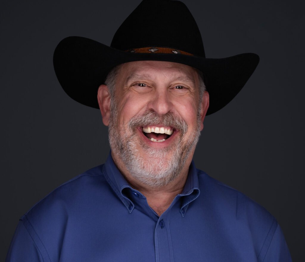 A Man laughing in a cowboy hat with Fort Worth Headshots