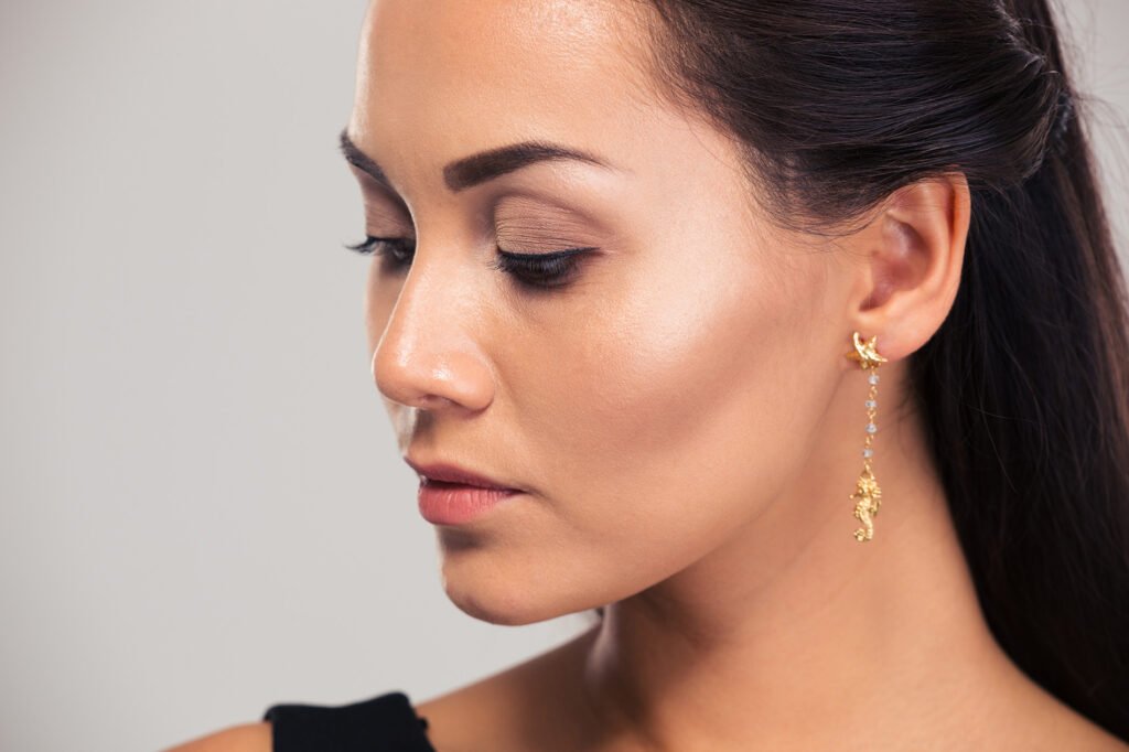 A woman wearing simple jewelry for her professional headshot
