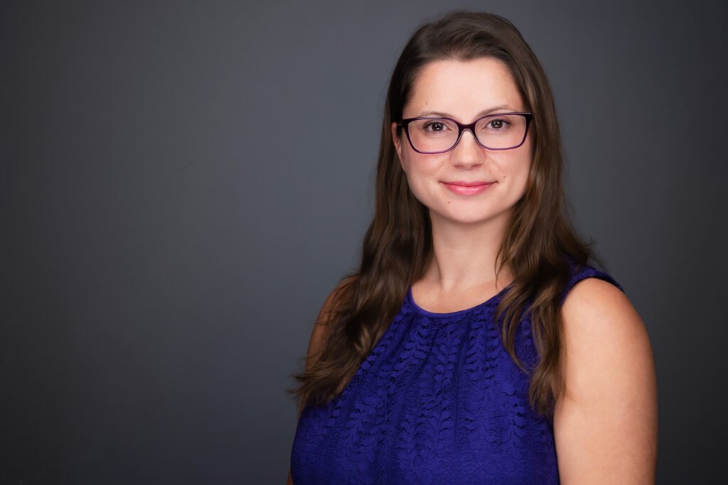 Employee receiving a professional headshot at their office workspace