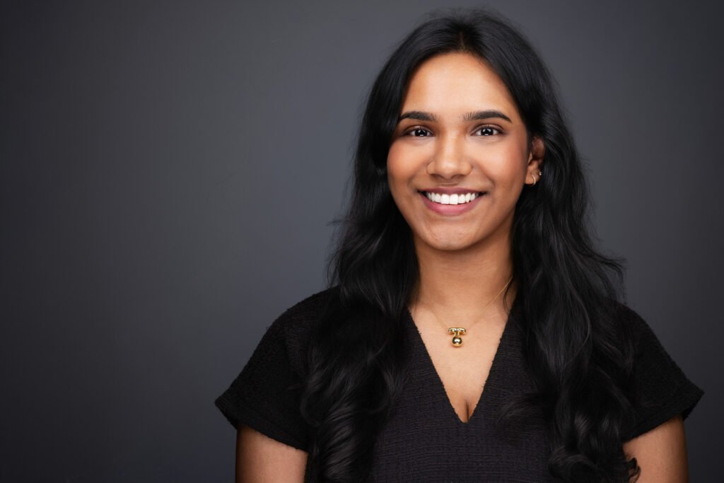 Employee receiving professional individual headshot session in corporate setting
