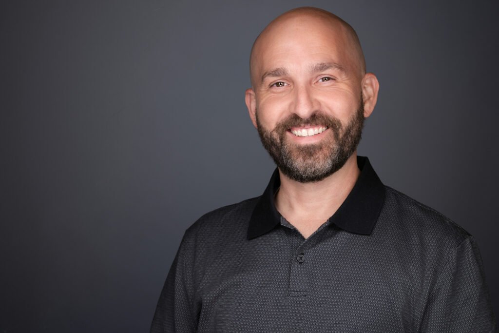 Attendees waiting in line for headshots at a trade show booth